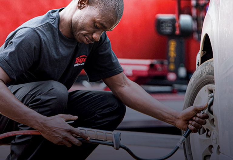 A Tiger Wheel & Tyre technician filling a tyre with nitrogen gas